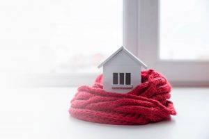 Model of Home Surrounded by Knit Scarf