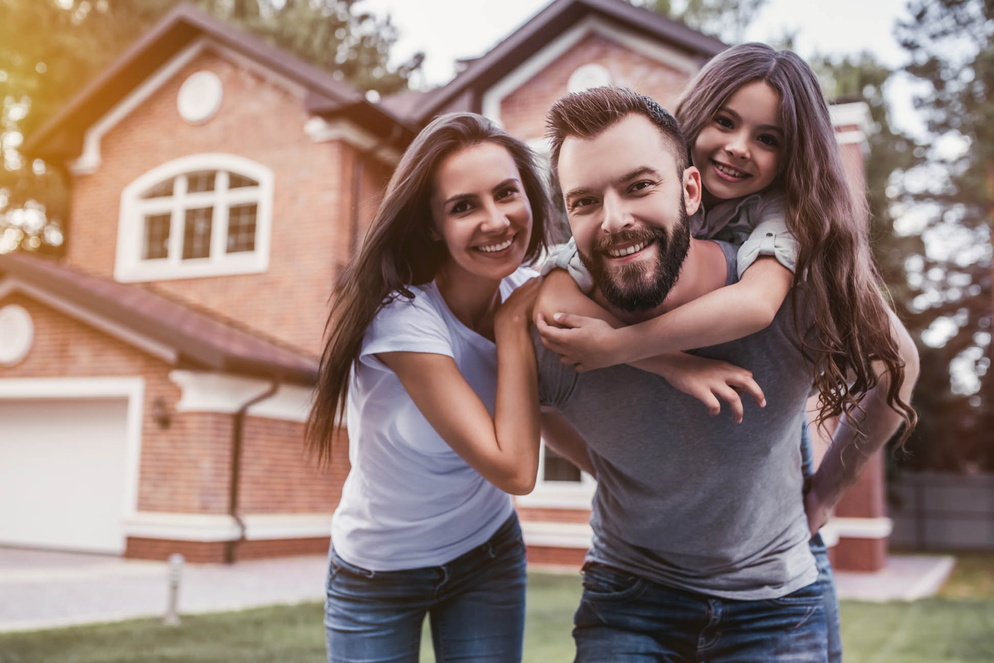 Smiling Family in Front of Home in Nassau County, NY