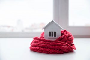 Model of Home Surrounded by Knit Scarf